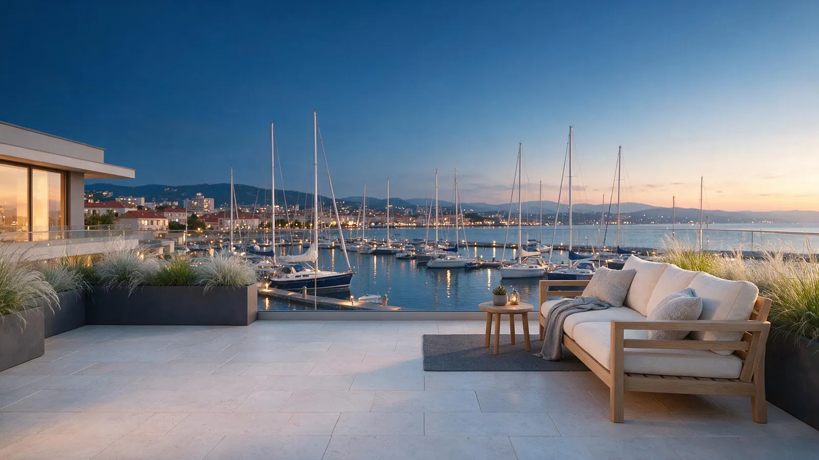Terraço privado ao anoitecer, com vista sobre os barcos atracados na marina.